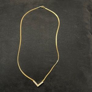 Womens 16” gold necklace with 9 rhinestone decoration. Gently used.